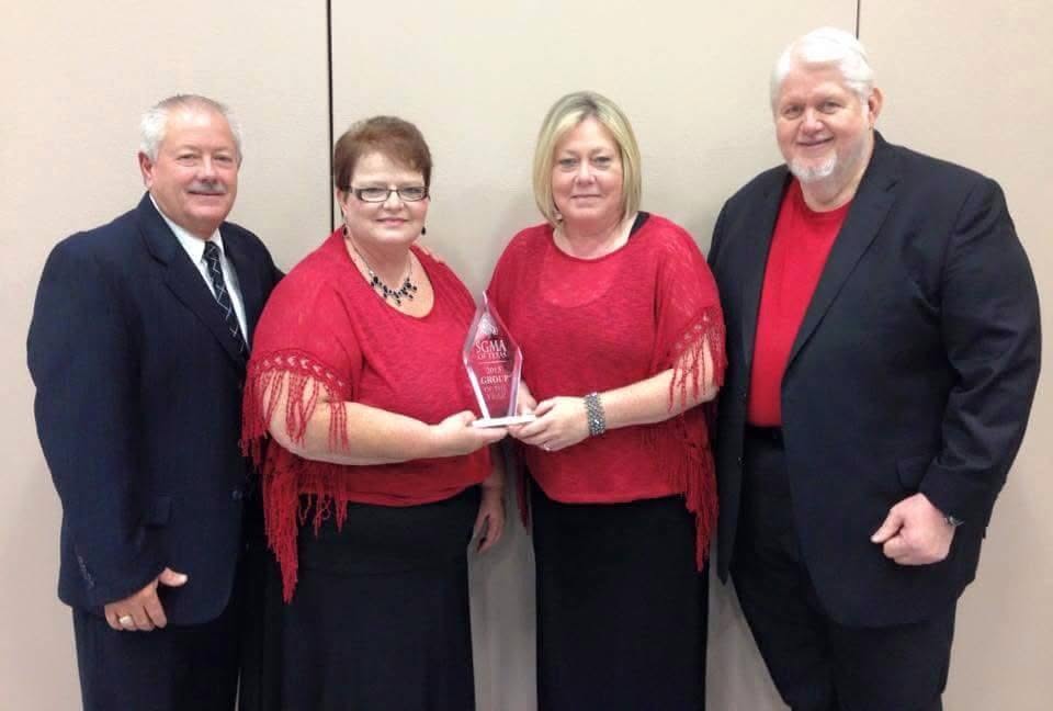 Master's Touch holding SGMA Group of the Year award