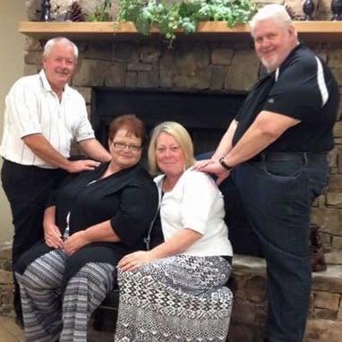 Master's Touch group portrait by the fireplace